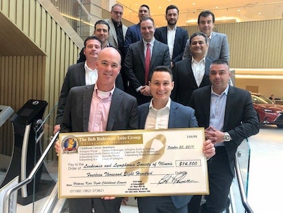 people holding donation check