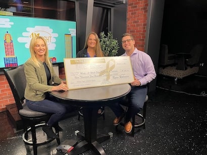 people holding donation check