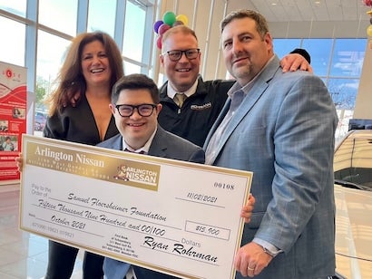 people holding donation check