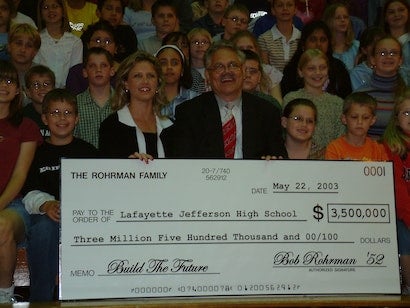 people holding donation check