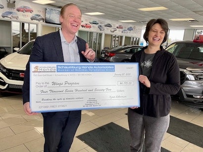 people holding donation check